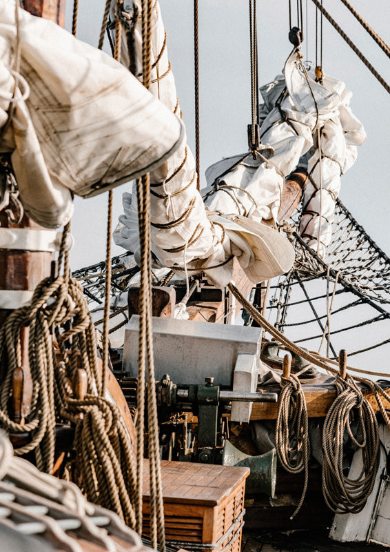 Close-up of ship rigging, ropes and furled sails on a traditional sailing boat
