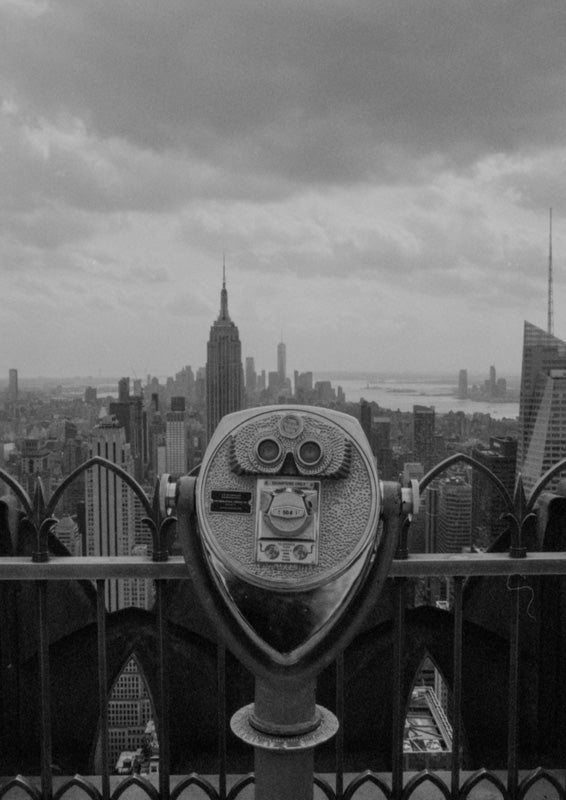 Monochrome photo of a coin viewfinder overlooking the New York City skyline