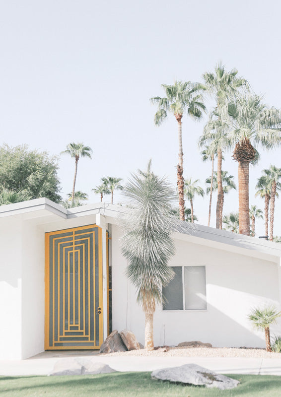 Mid-century Palm Springs house with mustard geometric door and palm trees