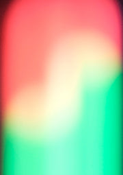 Blurred abstract gradient of coral pink, cream and emerald green with dark vignette edges.