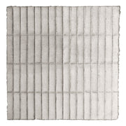 Textured paper artwork with a grid of creased lines and perforated dots on pale grey background