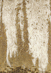 Abstract artwork of cream drips over a textured gold and bronze background