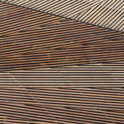 Wood slats arranged in angular diagonal patterns forming a geometric surface