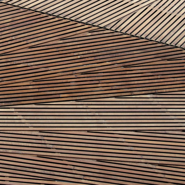 Wood slats arranged in angular diagonal patterns forming a geometric surface