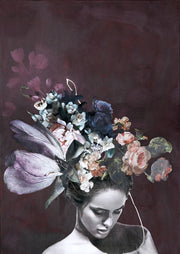Black and white portrait of a woman wearing an oversized painted floral headdress on a plum background