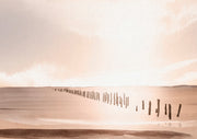 Watercolour landscape of wooden posts across a tidal flat under a blush sunset sky
