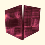 Abstract print of two angular raspberry-toned panels with textured striations on a cream background