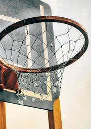 Close-up photograph of a weathered basketball hoop and net against a faded court backboard