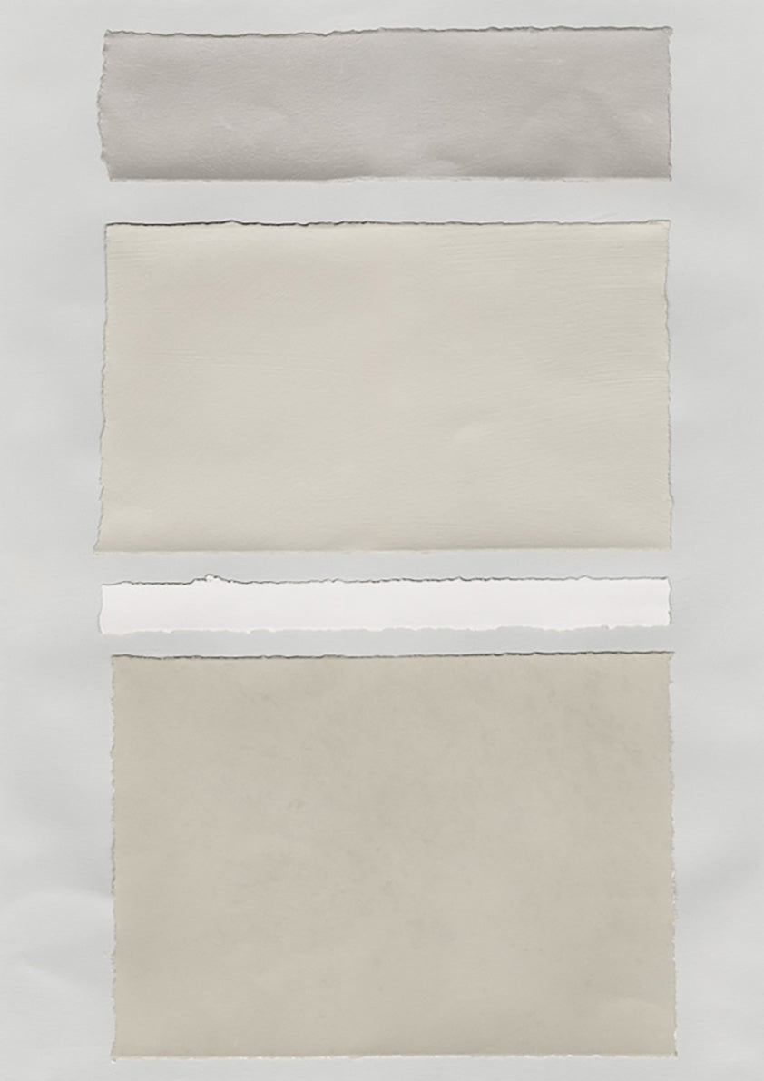 Torn paper swatches in gray, cream and white stacked in horizontal bands with deckled edges