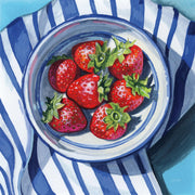 Painting of strawberries in a blue and white striped bowl on a striped cloth