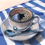 Painting of a black coffee cup and spoon on a blue and white striped cloth