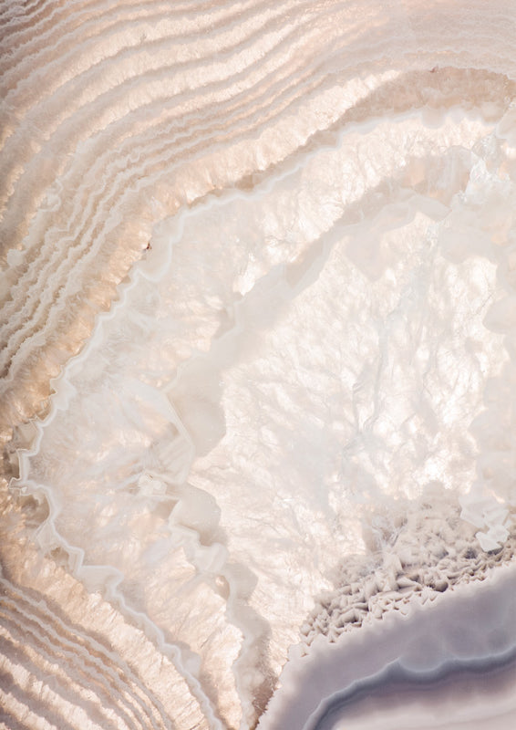 Macro photograph of banded agate crystal in cream, tan and grey tones