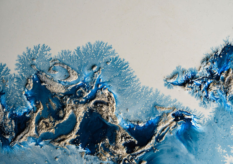 Abstract blue and silver fluid artwork with coral-like branching patterns on a pale background