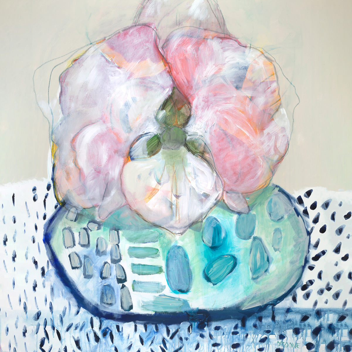 Pink and white orchid blooms in a speckled teal vessel on a dotted blue and white surface